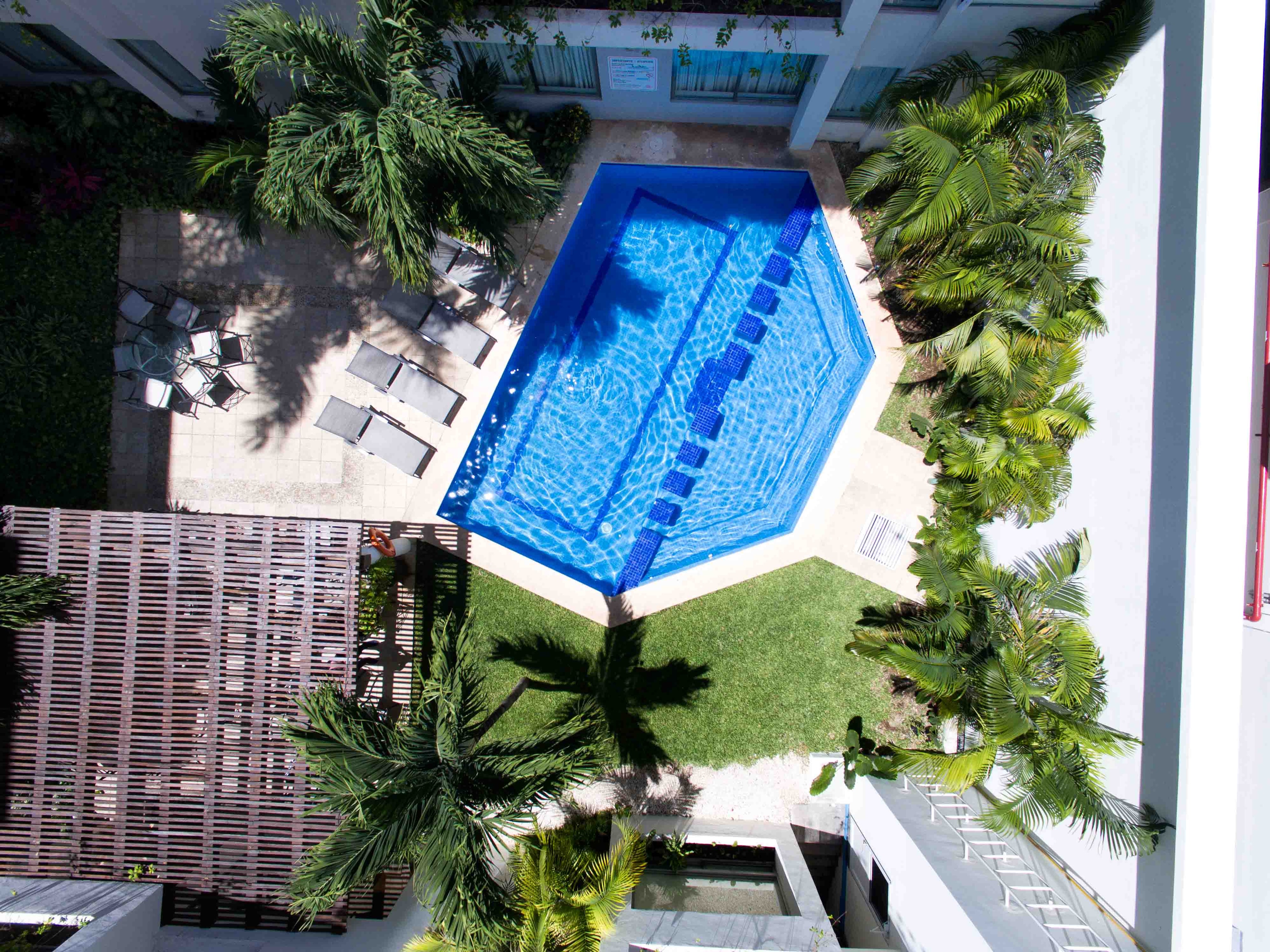 Aerial view of the hexagonal pool and tropical gardens at Ambiance Suites