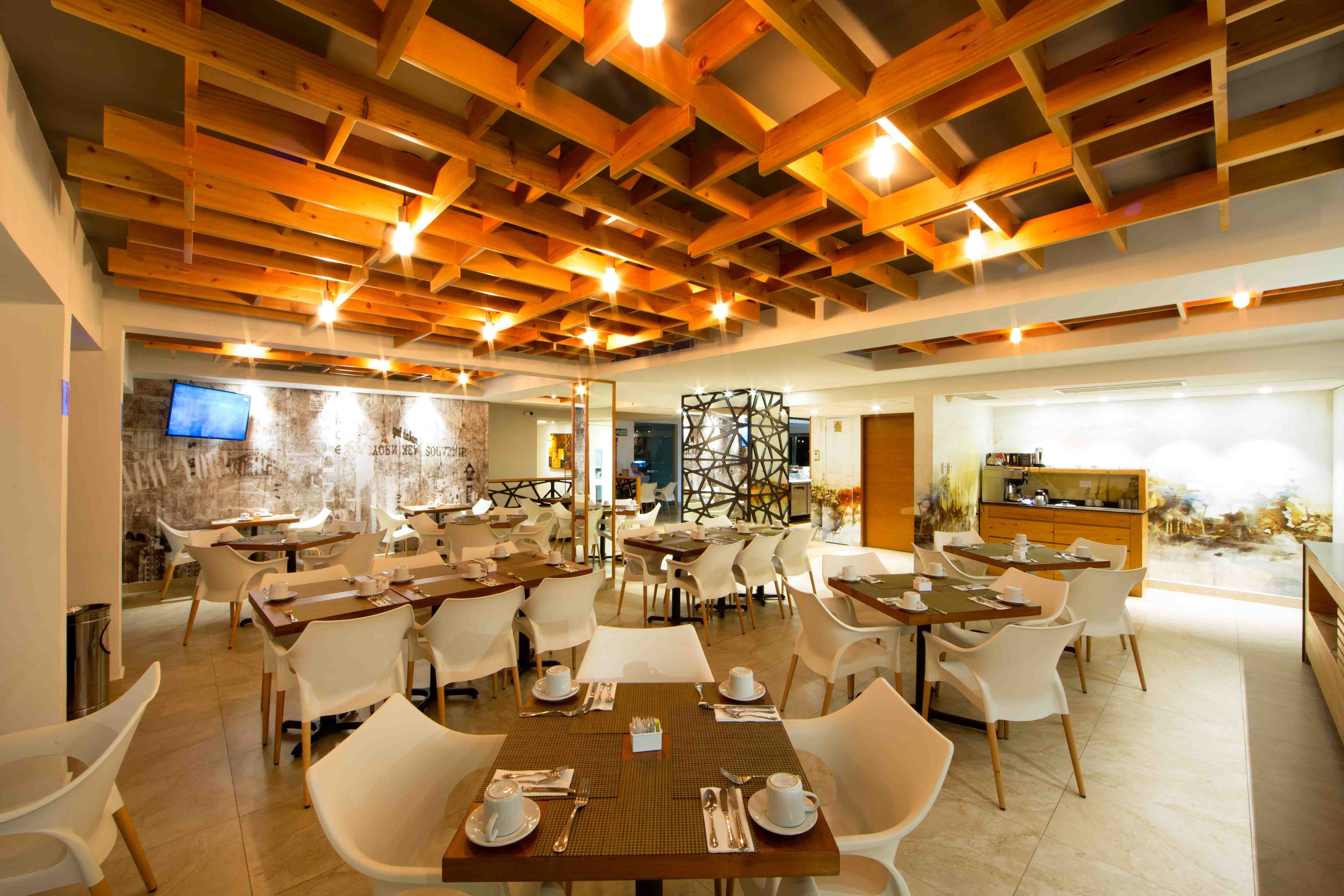 Restaurant interior with warm lighting and contemporary furnishings at Ambiance Suites