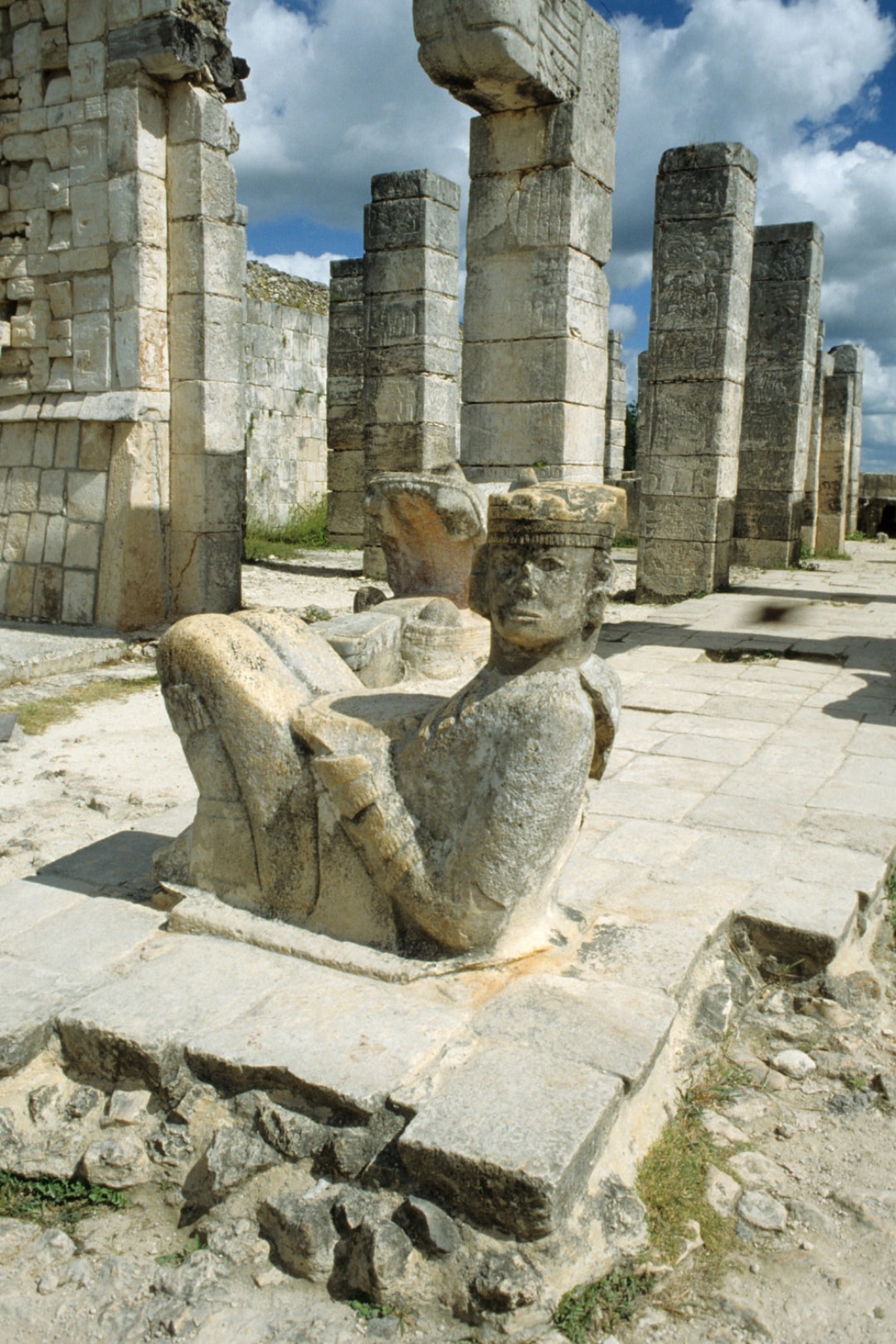 Chac Mool stone sculpture in front of the Temple of the Warriors columns at Chichen Itza