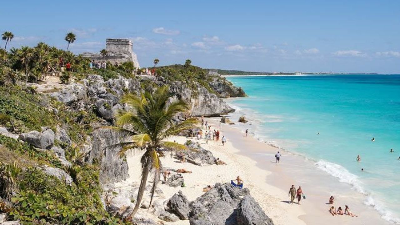 Tulum ruins overlooking the white-sand beach and turquoise Caribbean sea