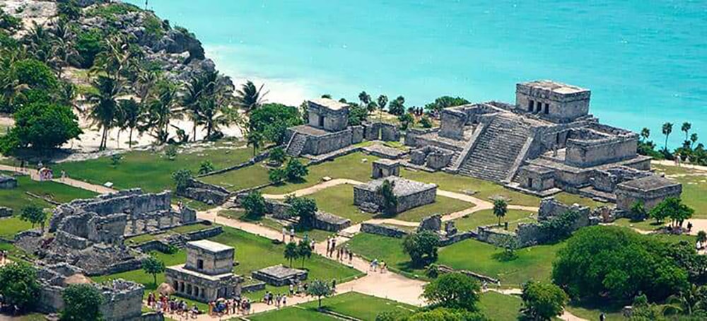 Aerial view of the full Tulum ruins complex with the Caribbean coast behind